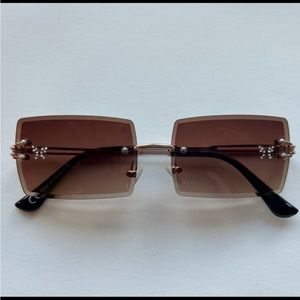 Ocean Beach Women’s Sunglasses with butterfly graphic on each lense.